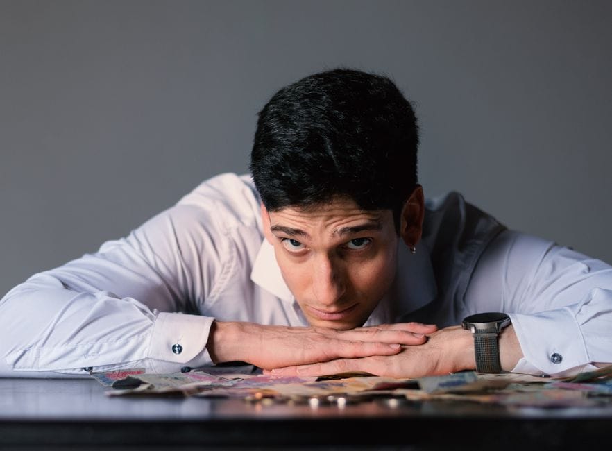 A stressed professional looking at a portfolio dashboard, illustrating the process of overcoming anxiety about net wealth.