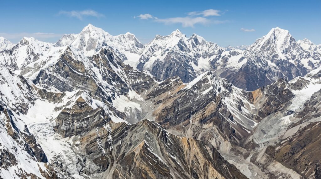 how mountains are formed through tectonic plate movement, volcanic activity, folding, faulting, and uplift, with famous examples.